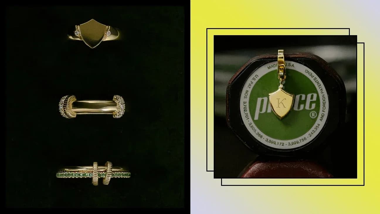 Varios anillos y un colgante de oro sobre fondo oscuro