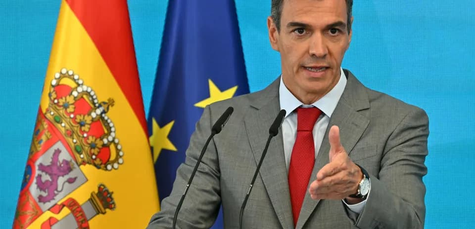 Político hablando en conferencia con banderas de fondo