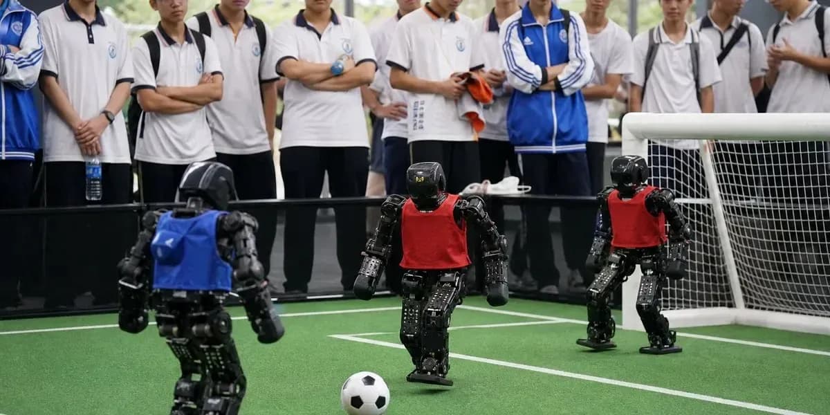 Robots playing soccer in front of spectators