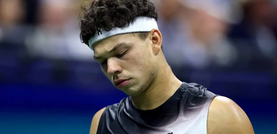Jugador de tenis con la cabeza agachada en la cancha