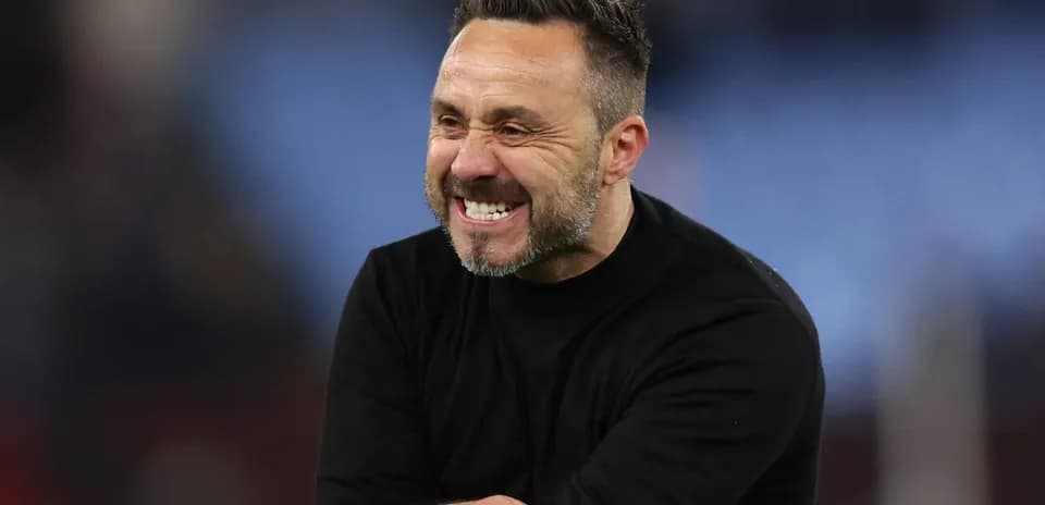 Entrenador sonriente en el campo durante el partido
