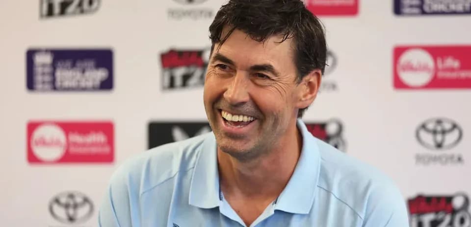 Entrenador sonriente en conferencia de prensa