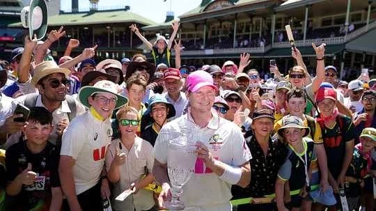 Jugador de cricket celebrando con aficionados tras el partido
