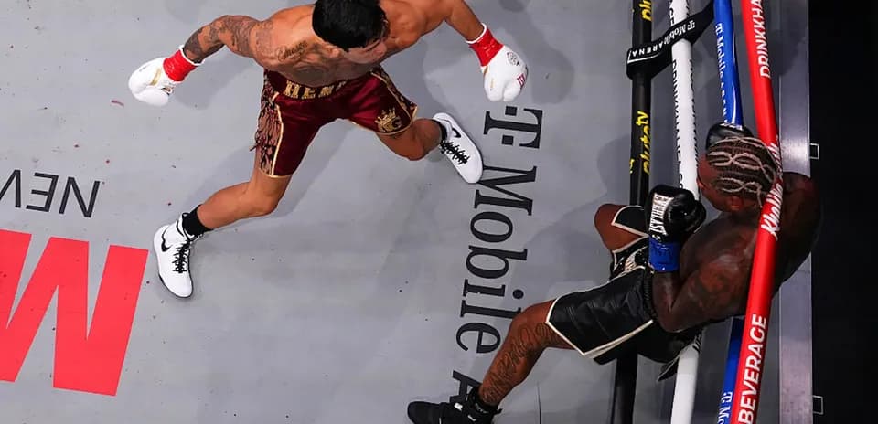 Boxer delivering a punch to opponent in ring
