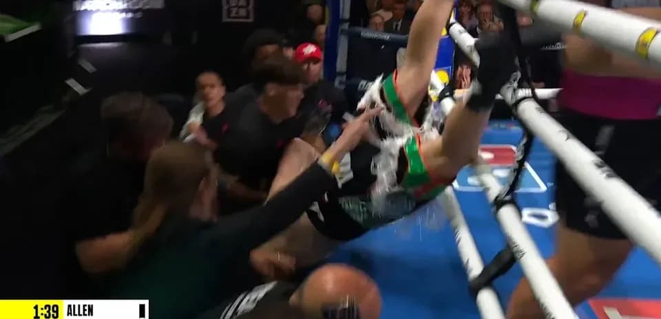 Boxer falling out of the ring during match