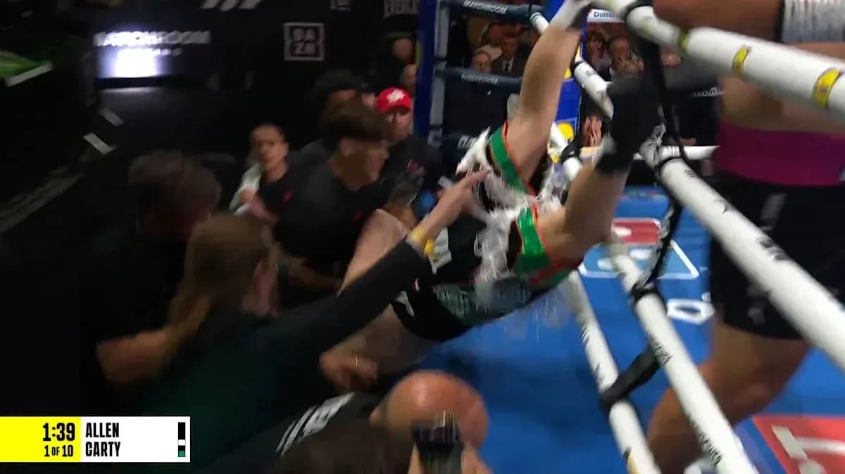 Boxer falling out of the ring during match