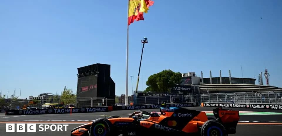 Coche de Fórmula 1 en circuito con bandera española