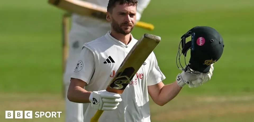 Jugador de cricket levantando su bate y casco