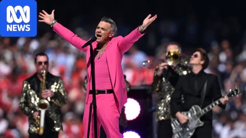 Robbie Williams cantando en un evento musical