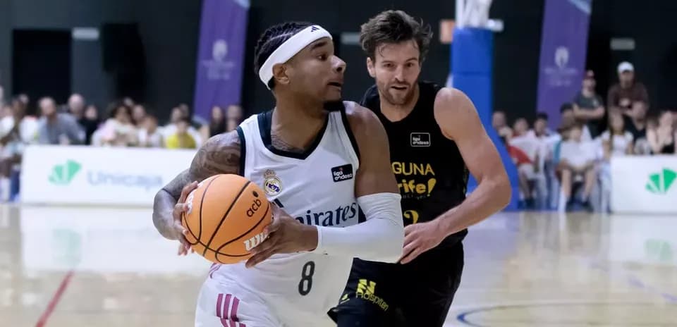 Jugador del Real Madrid driblando ante defensor rival