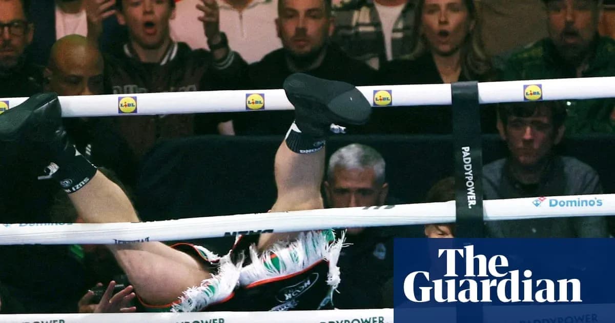 Boxer falling through the ropes during match Boxer falling through the ropes during match