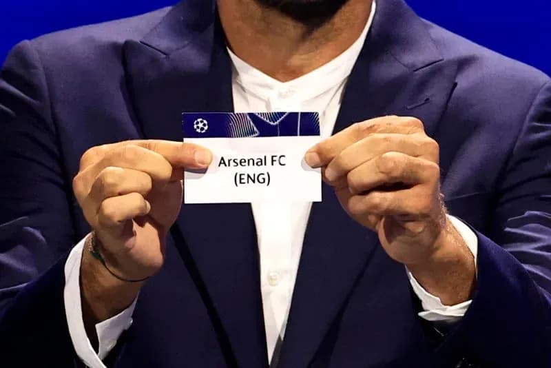 Persona sosteniendo tarjeta de Arsenal FC en sorteo Persona sosteniendo tarjeta de Arsenal FC en sorteo