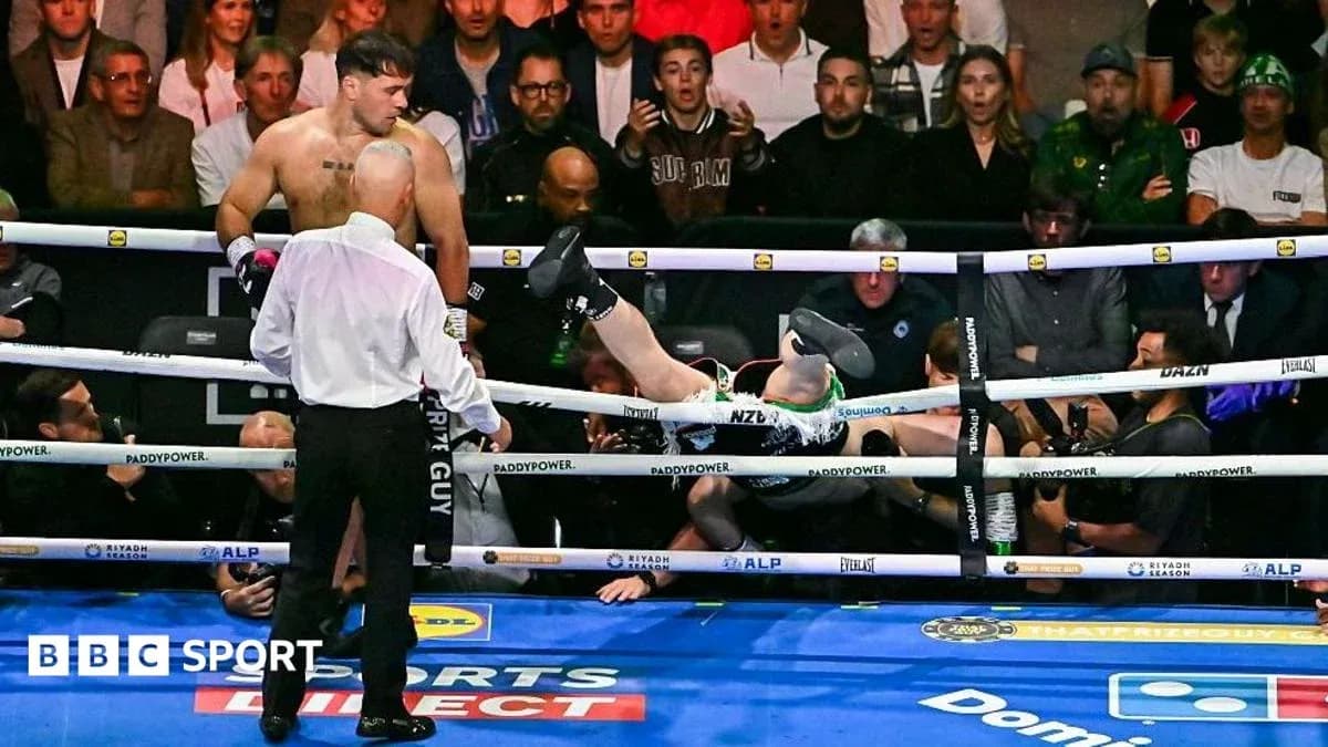 Boxer knocked out, lying outside the ring Boxer knocked out, lying outside the ring