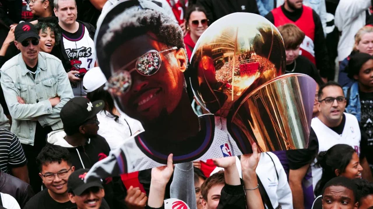 Fan holding a large cutout and trophy at celebration Fan holding a large cutout and trophy at celebration