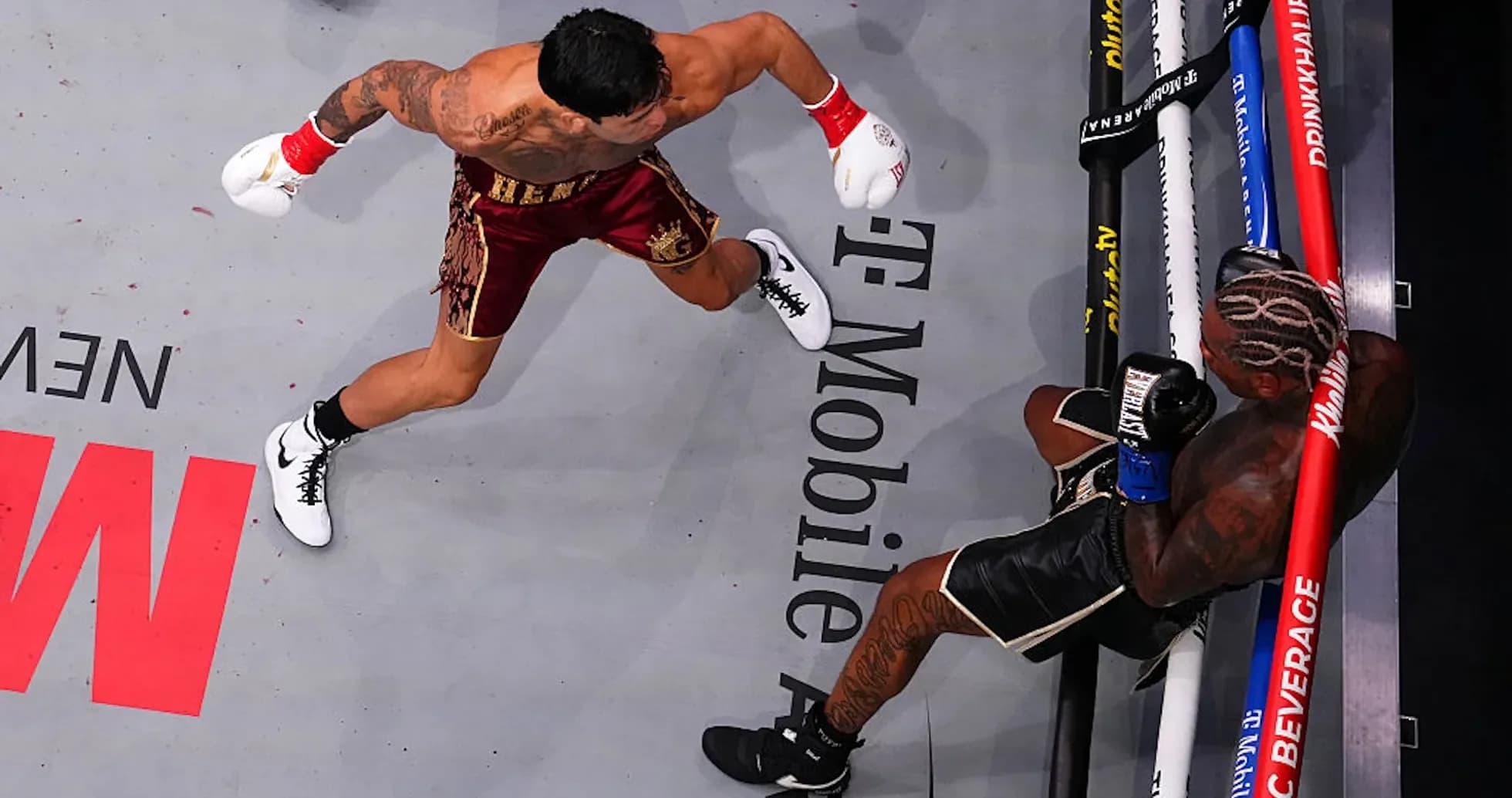 Boxer delivering a punch to opponent in ring Boxer delivering a punch to opponent in ring