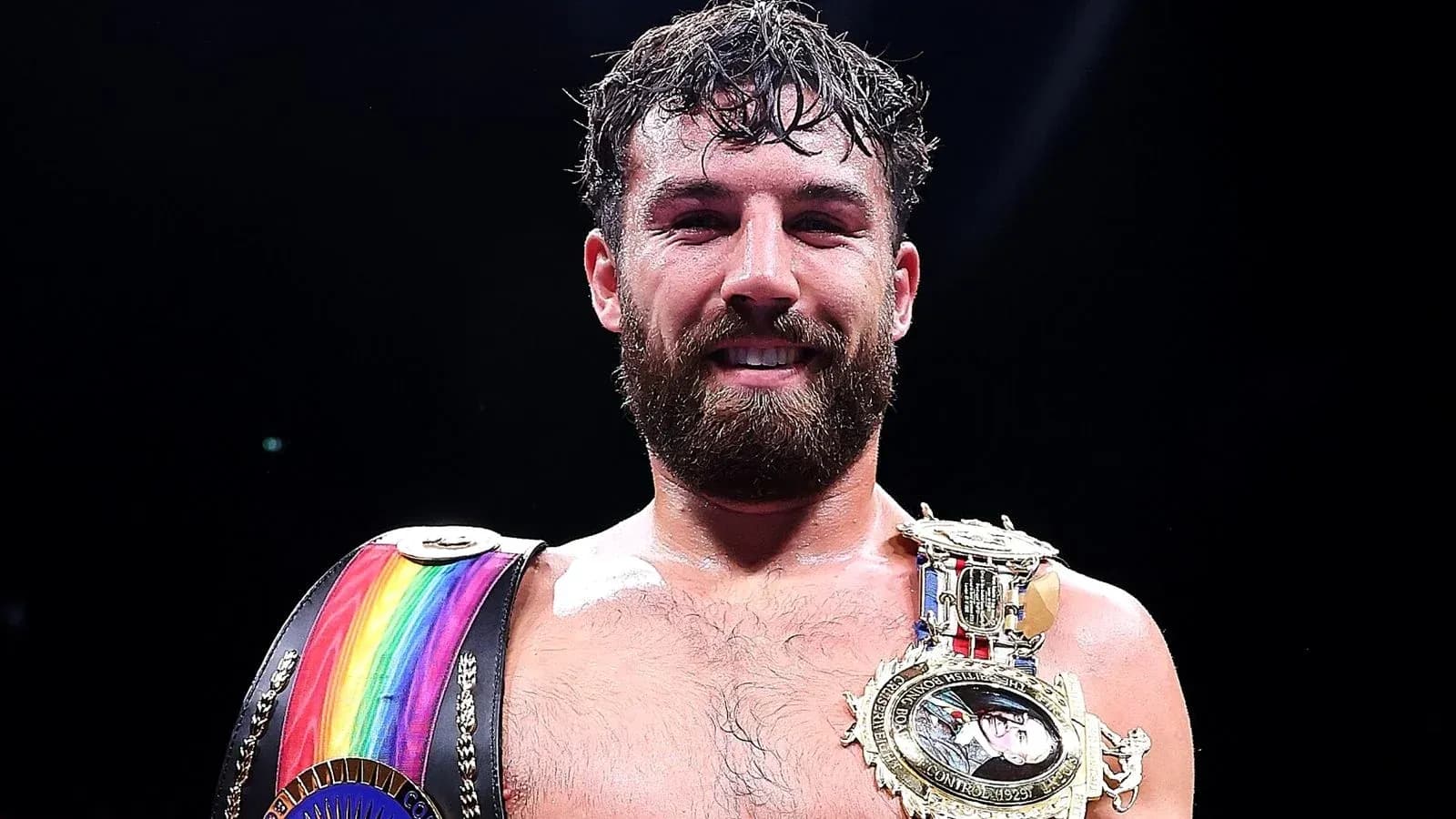 Boxeador sosteniendo cinturones de campeón sonriente Boxeador sosteniendo cinturones de campeón sonriente