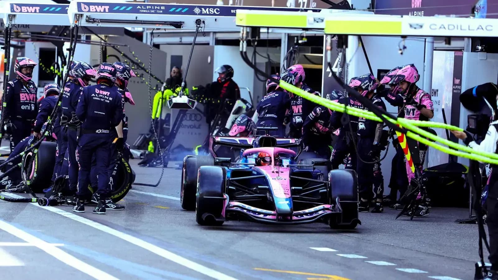 Alpine F1 team performing a pit stop during race Alpine F1 team performing a pit stop during race